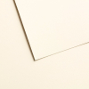 Two overlapping cream-colored sheets of paper with subtle shadows on a pale background (abstract background).