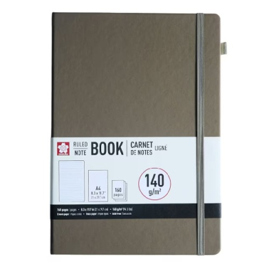 Brown hardcover notebook with a gray elastic band and a white label reading 'Ruled Notebook' and 140 g/m² paper.