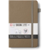 Brown kraft hardcover notebook with a gray elastic band and wrap-around label showing 140 g/m² paper