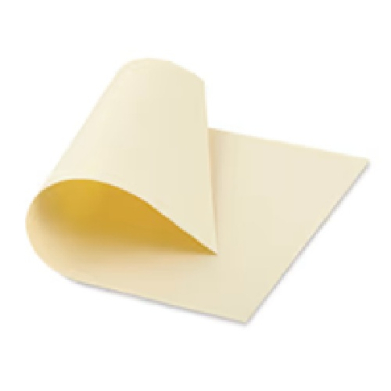 Cream-colored sheet of paper curling up at the corner, blank and ready for notes or writing.