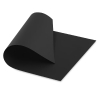 Black square sheet of paper curling up at one corner, viewed from above.