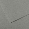 Close-up of overlapping gray textured paper sheets on a fabric-like background.