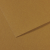 Close-up of brown cardboard with a folded edge creating a diagonal shadow and layered texture.
