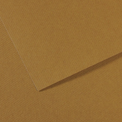 Close-up of brown cardboard with a folded edge creating a diagonal shadow and layered texture.