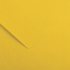 Close-up of yellow paper with a folded corner and soft shadow creating a diagonal line.