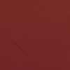Close-up of red-brown textured paper with a diagonal fold line forming a corner.