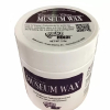 White jar labeled 'Museum Wax' with a purple label; used by museum professionals to secure artifacts.
