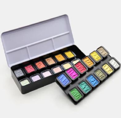 Open case of colorful watercolor pans arranged in two rows on a white background.