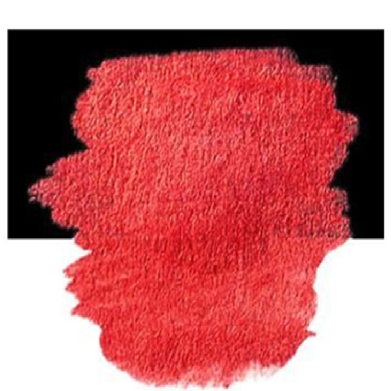 Red paint blob with irregular edges on a black background.